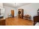 Spacious bedroom featuring beautiful hardwood floors and a vintage style closet with mirrored door at 2500 Kendrick Dr, Charlotte, NC 28214
