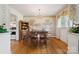 Charming dining room with hardwood floors, elegant chandelier, and scenic mural, perfect for Gathering gatherings at 2500 Kendrick Dr, Charlotte, NC 28214