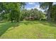A beautiful brick home is nestled on a large grassy lot with mature trees, offering a peaceful setting at 2500 Kendrick Dr, Charlotte, NC 28214