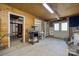 Spacious garage with wood paneling, ample shelving, and potential for workshop or storage at 2500 Kendrick Dr, Charlotte, NC 28214