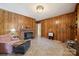 A living room featuring a brick fireplace and wood-paneled walls at 2500 Kendrick Dr, Charlotte, NC 28214