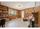 A cozy living room with wood paneling and built-in bookshelves at 2500 Kendrick Dr, Charlotte, NC 28214