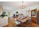 Bright and open living room featuring hardwood floors, fireplace and dining area in the background at 2500 Kendrick Dr, Charlotte, NC 28214