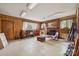 Spacious living room with wood paneling, brick fireplace, and natural light, a cozy area for relaxation at 2500 Kendrick Dr, Charlotte, NC 28214