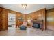 Living room featuring a brick fireplace and wood-paneled walls at 2500 Kendrick Dr, Charlotte, NC 28214