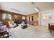 Living room with brick fireplace, wood paneling, and large windows at 2500 Kendrick Dr, Charlotte, NC 28214
