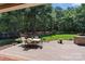 Backyard patio with outdoor dining set and lush greenery and trees providing a serene backdrop at 2590 Berne Ln, Sherrills Ford, NC 28673