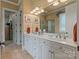 Bright bathroom with double sink vanity, marble countertops, decorative lighting, and separate shower and closet at 2590 Berne Ln, Sherrills Ford, NC 28673