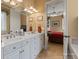 Bright bathroom with double sink vanity, marble countertops and open doorway to main bedroom at 2590 Berne Ln, Sherrills Ford, NC 28673