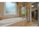 Bright bathroom with tiled floors, large soaking tub, and glass enclosed shower at 2590 Berne Ln, Sherrills Ford, NC 28673