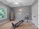 Bedroom with a ceiling fan, a window that looks onto the outside, and a total gym work out machine at 2590 Berne Ln, Sherrills Ford, NC 28673
