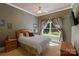 Comfortable bedroom featuring a ceiling fan, natural light, neutral colors, and wood furniture at 2590 Berne Ln, Sherrills Ford, NC 28673