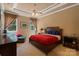 Comfortable bedroom with a tray ceiling, ceiling fan, and two windows providing ample natural light at 2590 Berne Ln, Sherrills Ford, NC 28673