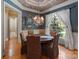 Elegant dining room with decorative ceiling, chandelier, and large window with sheer curtains at 2590 Berne Ln, Sherrills Ford, NC 28673