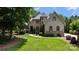 Charming stone and stucco home with manicured lawn and lush landscaping on a sunny day at 2590 Berne Ln, Sherrills Ford, NC 28673