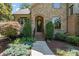 Inviting front entrance with stone facade, arched doorway, and professionally landscaped walkway at 2590 Berne Ln, Sherrills Ford, NC 28673