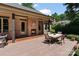 A lovely outdoor patio with a brick fireplace, a dining table and chairs, and a well-manicured garden at 2590 Berne Ln, Sherrills Ford, NC 28673