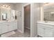 Bright bathroom with double sinks, tile floors, white cabinets, and a view into the shower at 314 Candella Dr, Matthews, NC 28104