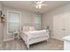 Bright bedroom with white wrought iron bed, neutral walls, and a ceiling fan for a cozy feel at 314 Candella Dr, Matthews, NC 28104