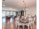 Spacious dining area featuring a chandelier, hardwood floors, and open to the living area at 314 Candella Dr, Matthews, NC 28104