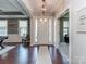 Welcoming foyer featuring hardwood floors, decorative lighting, and an open view to other living spaces at 314 Candella Dr, Matthews, NC 28104