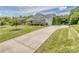 Lovely home with an extended driveway leading to a side-entry garage and mature landscaping at 314 Candella Dr, Matthews, NC 28104