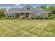 Charming brick home featuring manicured landscaping and a well-maintained, expansive front lawn at 314 Candella Dr, Matthews, NC 28104