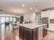 Bright eat-in kitchen with granite countertops, stainless appliances and an open plan to living room at 314 Candella Dr, Matthews, NC 28104
