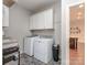 Functional laundry room with modern washer, dryer, and cabinetry for efficient organization at 314 Candella Dr, Matthews, NC 28104