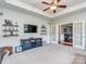 Spacious living room with a TV, neutral carpet, and an open doorway to another room at 314 Candella Dr, Matthews, NC 28104