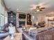 Open concept living room with stone fireplace, built-in shelving and hardwood floors at 314 Candella Dr, Matthews, NC 28104