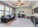 Comfortable living room with neutral carpet, large windows, and a ceiling fan for relaxation at 314 Candella Dr, Matthews, NC 28104