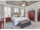 Main bedroom featuring a tray ceiling, carpet, and windows with shutters at 314 Candella Dr, Matthews, NC 28104