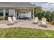 Relaxing covered patio with comfortable seating, a grill, and a landscaped yard at 314 Candella Dr, Matthews, NC 28104