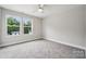 Bright bedroom with large windows showcasing the surrounding greenery at 384 Speedway Pl, Concord, NC 28027