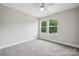 A clean bedroom space, featuring large windows offering a view of the nature outside at 384 Speedway Pl, Concord, NC 28027