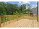 Wooden deck overlooking the backyard, surrounded by lush greenery at 384 Speedway Pl, Concord, NC 28027