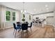 Elegant dining area with a round table, blue chairs, and views of the modern kitchen at 384 Speedway Pl, Concord, NC 28027