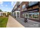 Retail storefronts with brick facade and awnings offer a charming neighborhood shopping experience at 384 Speedway Pl, Concord, NC 28027