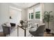 Well-lit home office with a glass desk, comfortable seating, and a view to the outside at 384 Speedway Pl, Concord, NC 28027