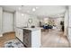 Modern kitchen island with stainless steel dishwasher opens to a dining area with seating at 384 Speedway Pl, Concord, NC 28027