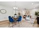 Cozy living room with a ceiling fan and comfortable furniture that opens to the dining area at 384 Speedway Pl, Concord, NC 28027