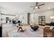 Bright open-concept living room with elegant furniture and seamless access to the kitchen and dining area at 384 Speedway Pl, Concord, NC 28027