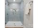 Modern shower with light blue subway tile and built-in shelving for storage at 384 Speedway Pl, Concord, NC 28027