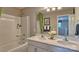 Well-lit bathroom with a dual sink vanity, tub-shower combination, and modern fixtures, designed for comfort and style at 3862 Maxwell Henry Nw Ln, Conover, NC 28613