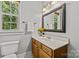 Bathroom featuring a window, traditional-style vanity, and decorative mirror at 4025 Cherrybrook Dr, Mint Hill, NC 28227