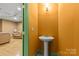 Cozy bathroom adjacent to a living space featuring modern sink fixtures and lighting at 4025 Cherrybrook Dr, Mint Hill, NC 28227
