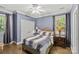Blue bedroom featuring neutral-colored furniture and carpet plus two sunny windows at 4025 Cherrybrook Dr, Mint Hill, NC 28227