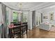 A well-lit dining area adjacent to the living room features a stylish light fixture and hardwood floors at 4025 Cherrybrook Dr, Mint Hill, NC 28227