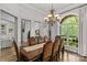 Bright dining room with a large window, chandelier, and elegant seating for a large party at 4025 Cherrybrook Dr, Mint Hill, NC 28227
